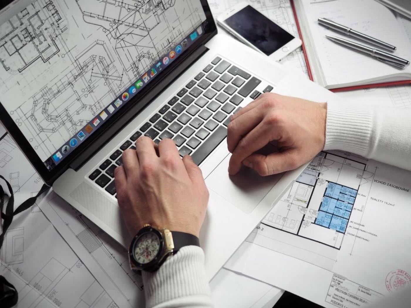 A laptop on a desk, comparing website builders with hiring a web designer